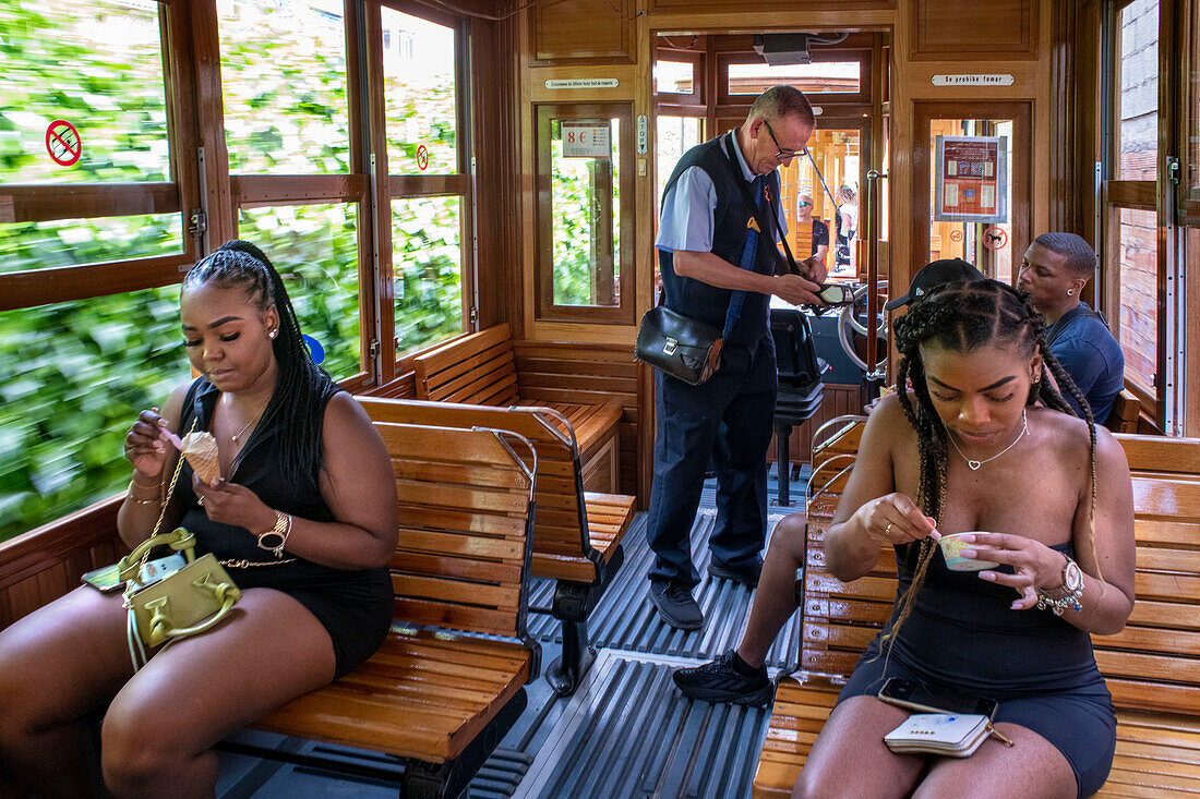Tourists inside of the vintage tram at the Soller village. The tram operates a 5kms service from the railway station in the Soller village to the Puerto de Soller, Soller Majorca, Balearic Islands, Spain, Mediterranean, Europe.