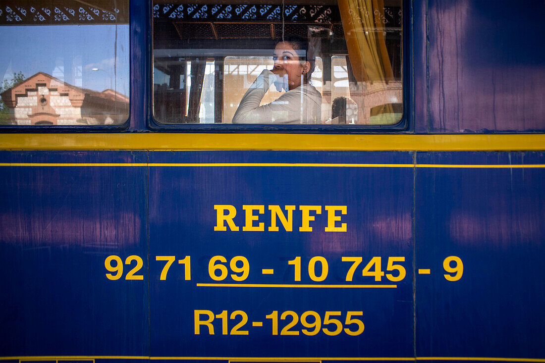 Strawberry train parked at Aranjuez train station, Madrid, Spain. Renfe Logo and trade mark.