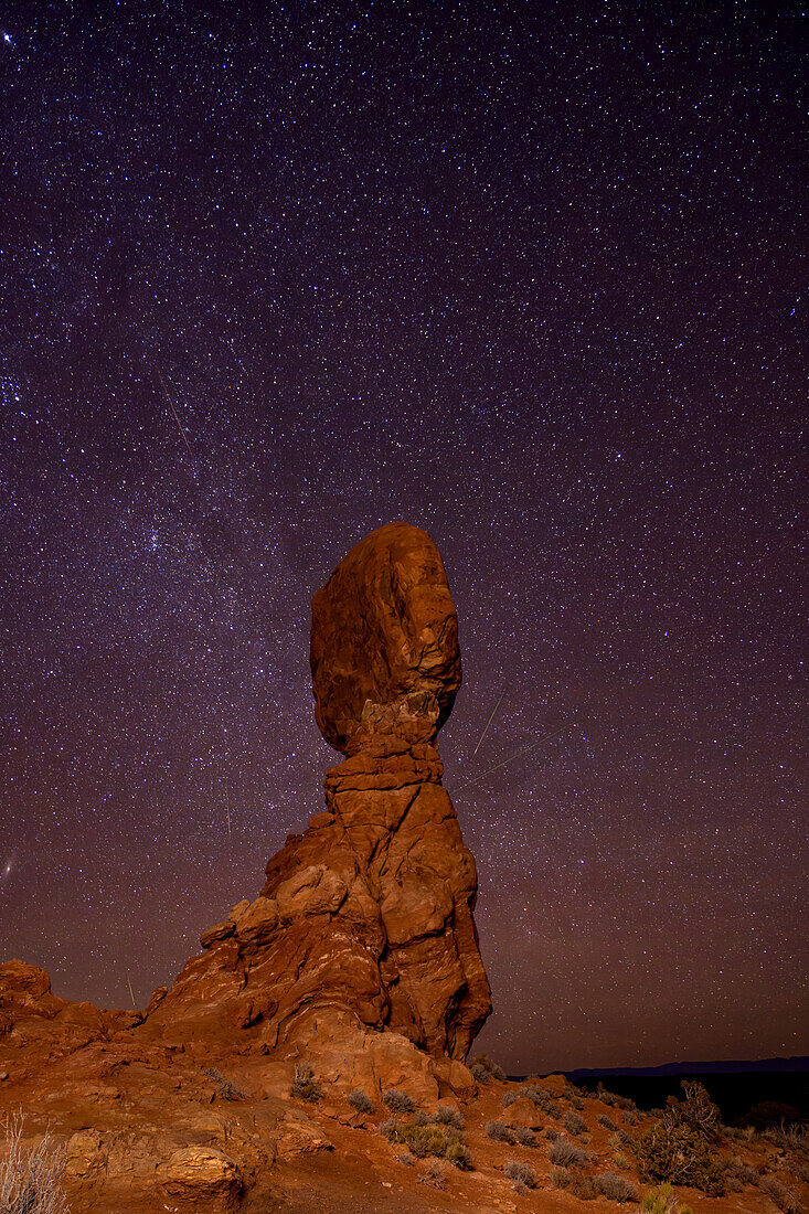 Geminid Meteor Shower over Balanced Rock in Arches National Park in Utah. Composite image shows 5 faint meteorites over a 2-hour period.