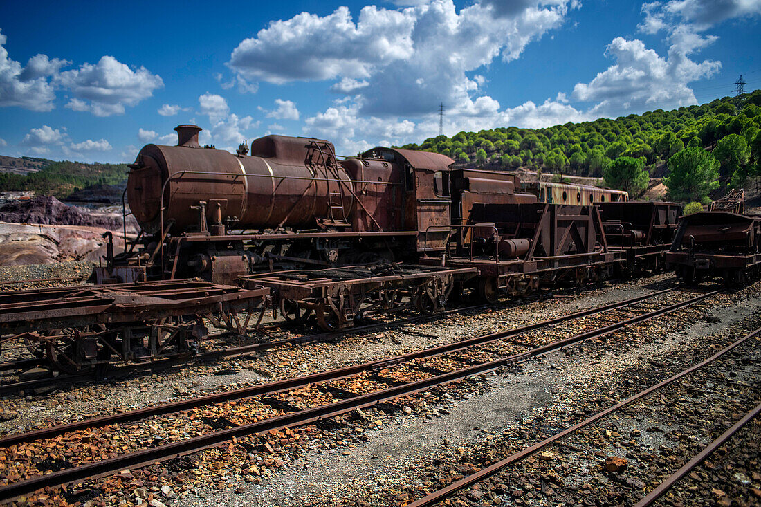 Old abandoned steam trains seen from the touristic train used for tourist trip through the RioTinto mining area, Huelva province, Spain.