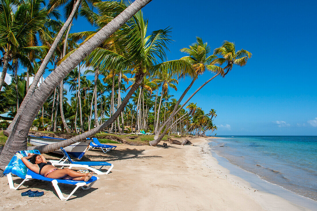 Girl relaxing on the beach in Playa bonita beach on the Samana peninsula in Dominican Republic near the Las Terrenas town.