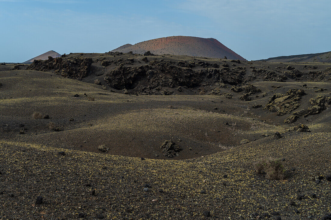 Volcan del Cuervo (Crow volcano) a crater explored by a loop trail in a barren, rock-strewn landscape