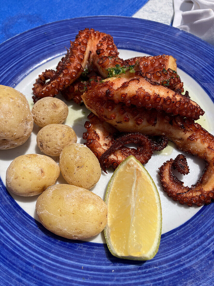 Grilled octopus and papas in restaurant, Lanzarote, Spain