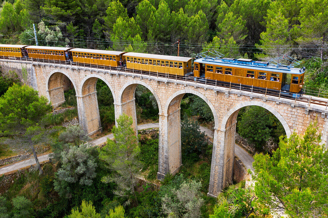 Aerial view tren de Soller train vintage historic train crossing the viaduct Cinc-Ponts. That train connects Palma de Mallorca to Soller, Majorca, Balearic Islands, Spain, Mediterranean, Europe.