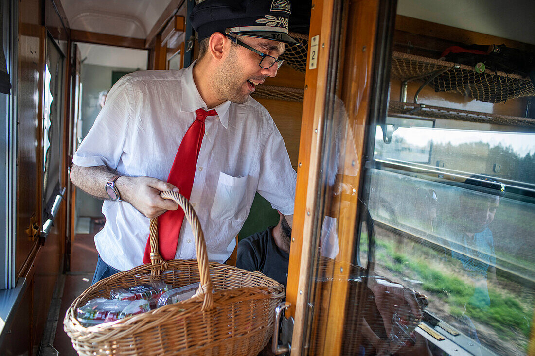 Staff distributing strawberries inside the Strawberry train that goes from Madrid Delicias train station to Aranjuez city Madrid, Spain.