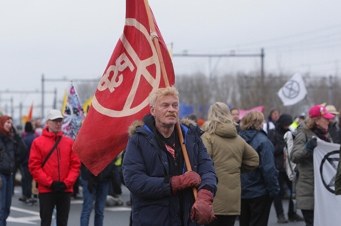 Extinction Rebellion climate activists gather to block the main highway A10 in front of the former headquarters of Dutch multinational bank on December 30, 2023 in Amsterdam,Netherlands. Environmental protectors of Extinction Rebellion make a demonstration against ING bank to protest its financing of fossil fuels.