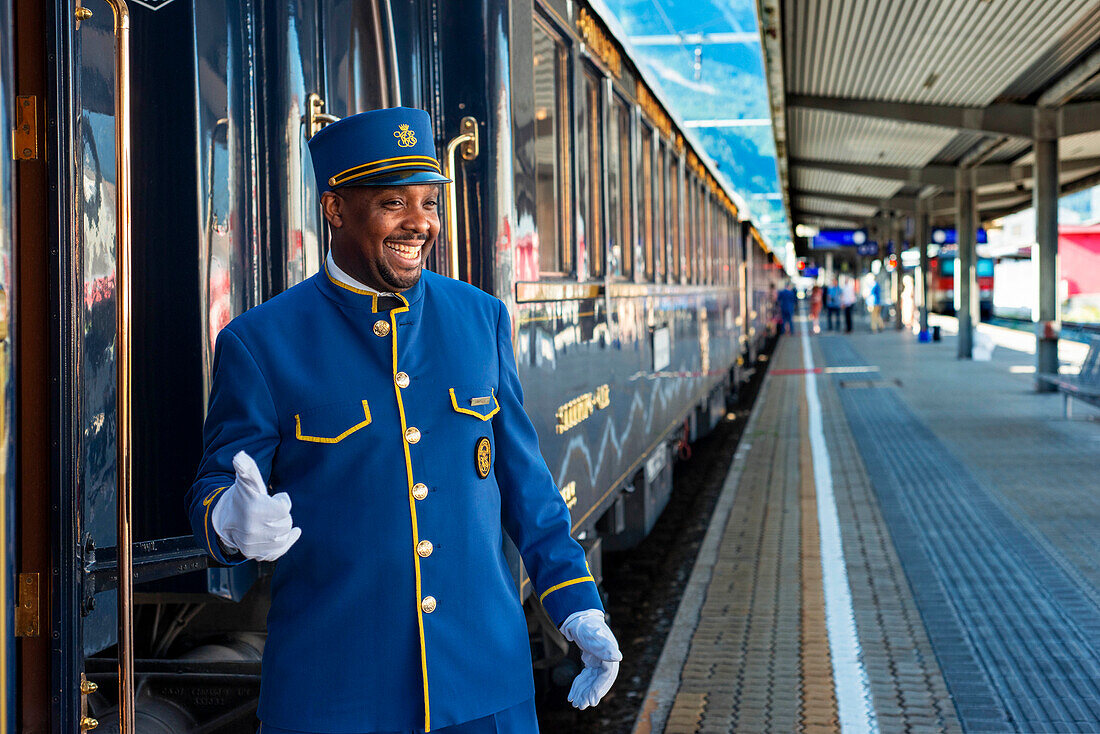 Staff of Belmond Venice Simplon Orient Express luxury train stoped at Innsbruck Hauptbahnhof train station railway station the central railway station in Innsbruck Austria.