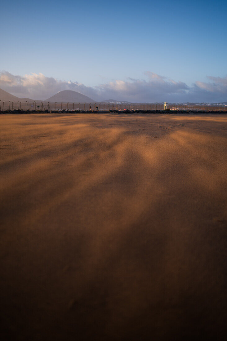Wind blows sand on a beach in Lanzarote, Canary Islands, Spain