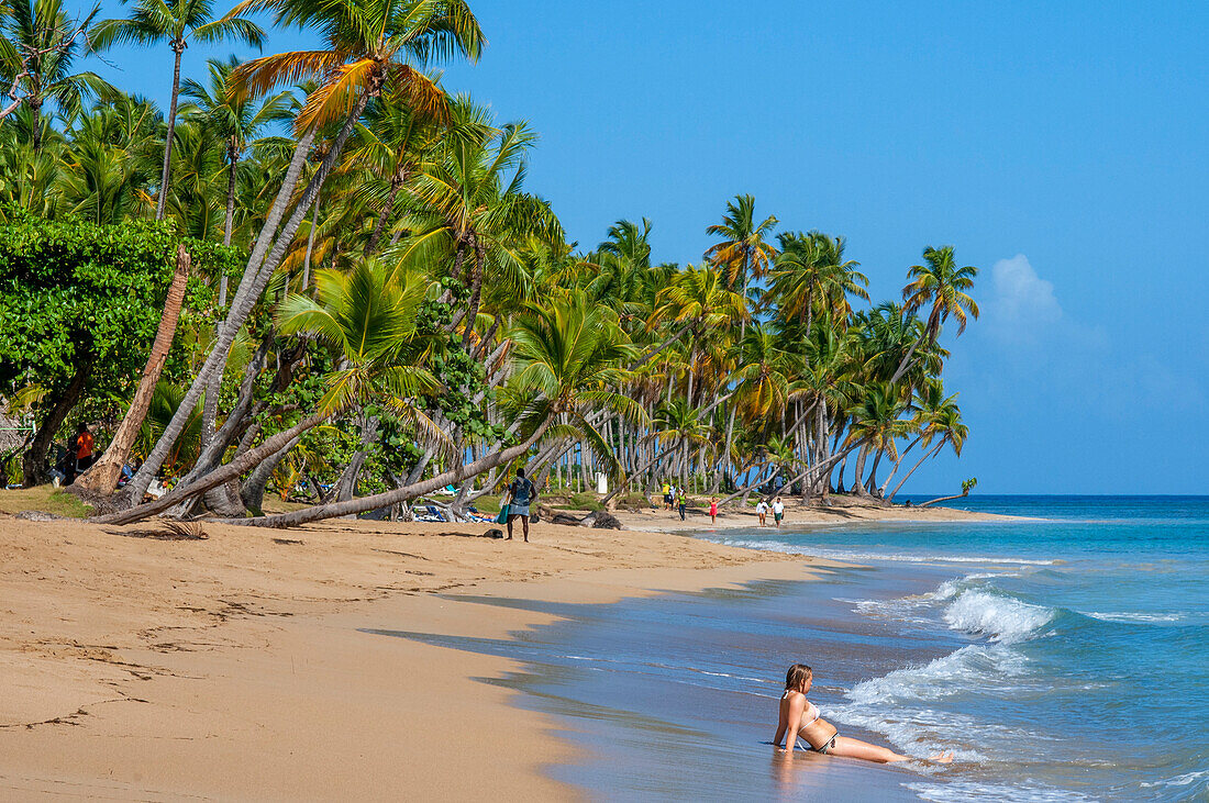 Tourist girl in playa bonita beach on the Samana peninsula in Dominican Republic near the Las Terrenas town.
