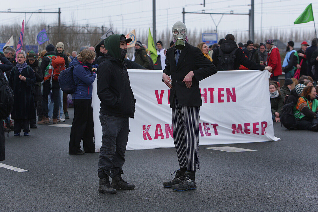 Extinction Rebellion climate activists gather to block the main highway A10 in front of the former headquarters of Dutch multinational bank on December 30, 2023 in Amsterdam,Netherlands. Environmental protectors of Extinction Rebellion make a demonstration against ING bank to protest its financing of fossil fuels.