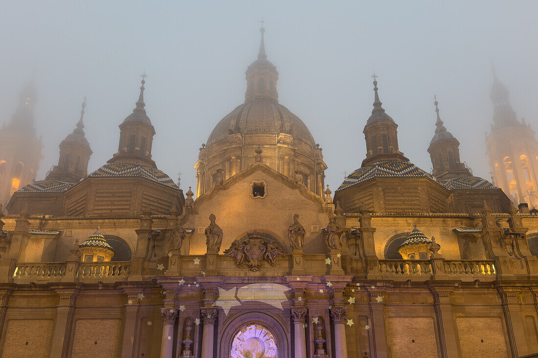 Cathedral-Basilica of Our Lady of the Pillar covered in fog as temperatures go down in Zaragoza, Spain