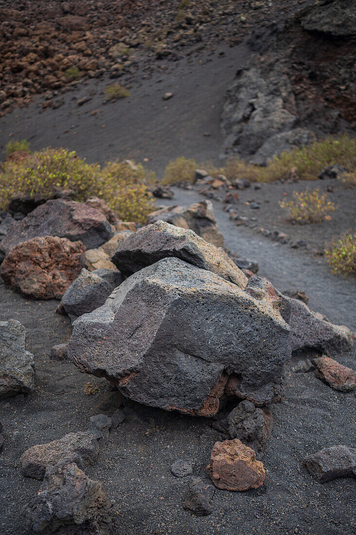 Volcan del Cuervo (Crow volcano) a crater explored by a loop trail in a barren, rock-strewn landscape