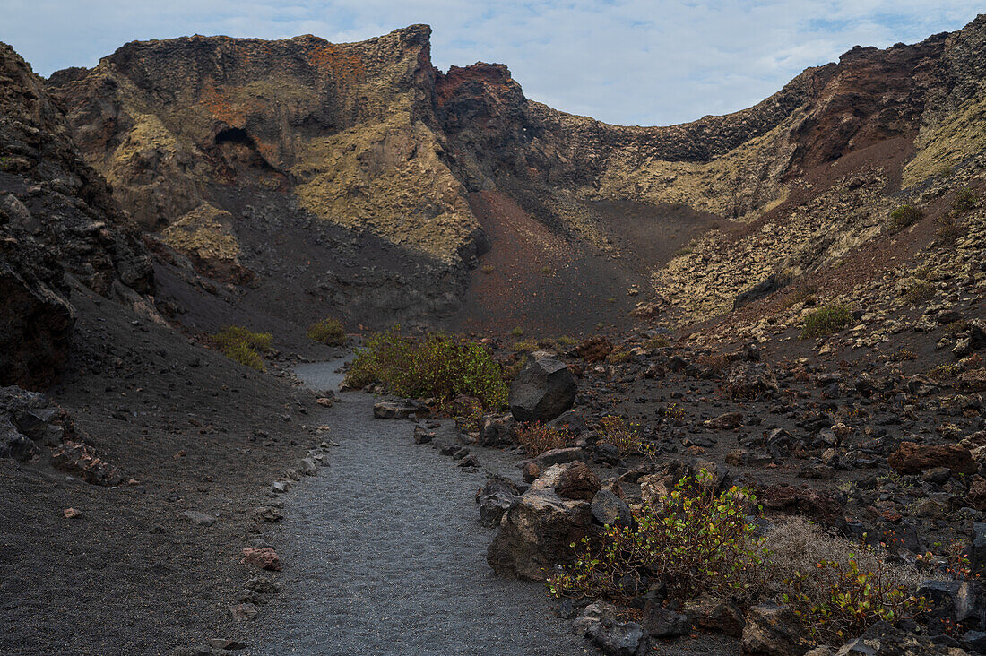 Volcan del Cuervo (Crow volcano) a crater explored by a loop trail in a barren, rock-strewn landscape