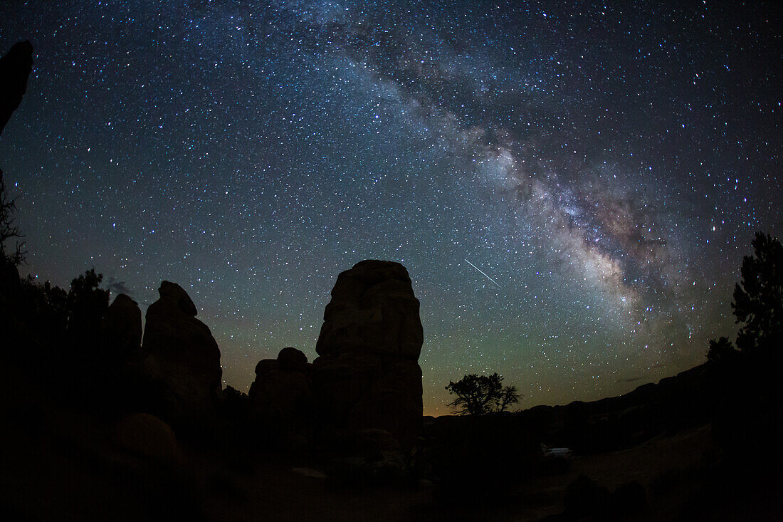 A shooting star & the Milky Way over sandstone towers in the Needles District of Canyonlands National Park in Utah.