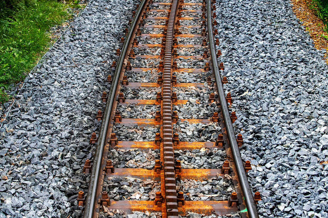 The Petit train de la Rhune rack railway, La Rhun mountain on the border with Spain, France. Train tracks of the historic funicular from 1924 up to the summit of La Rhune Mountain, 905m, Basque Country, Pyrenees