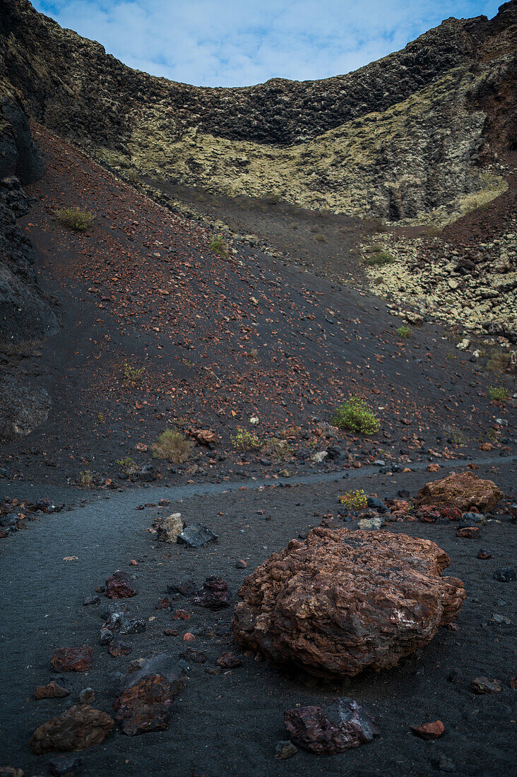 Volcan del Cuervo (Crow volcano) a crater explored by a loop trail in a barren, rock-strewn landscape