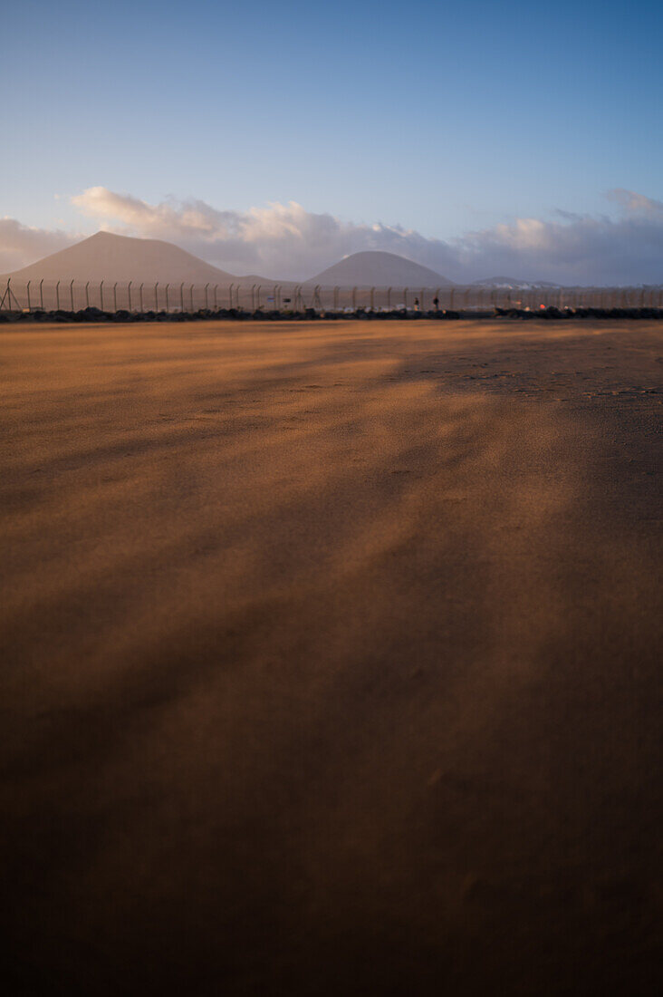 Wind blows sand on a beach in Lanzarote, Canary Islands, Spain