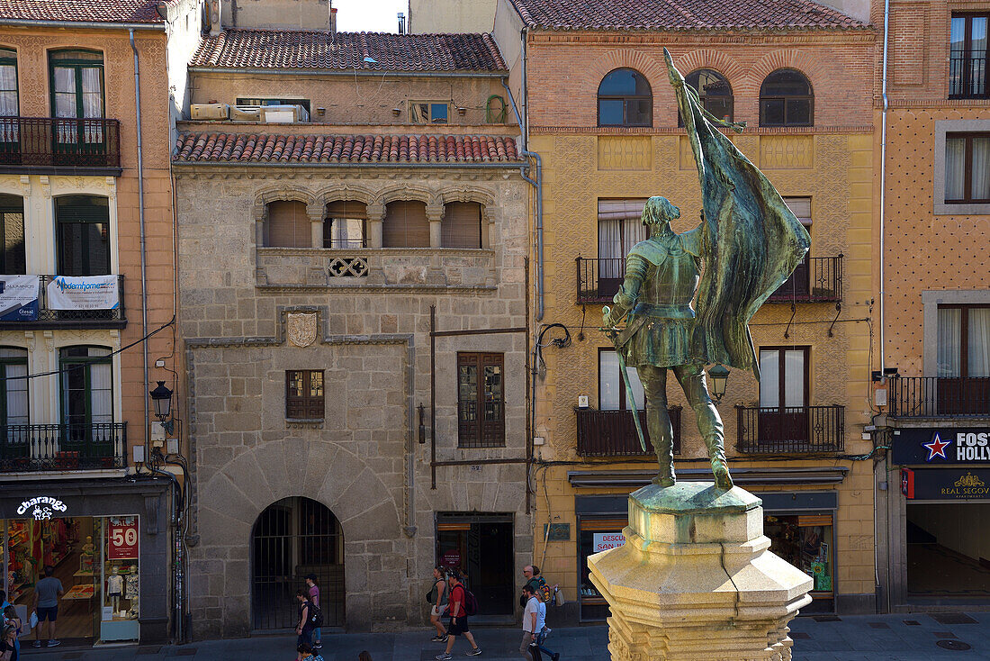 The statue of Juan Bravo and the Renaissance palaces of Medina del Campo square in the city center of Segovia.