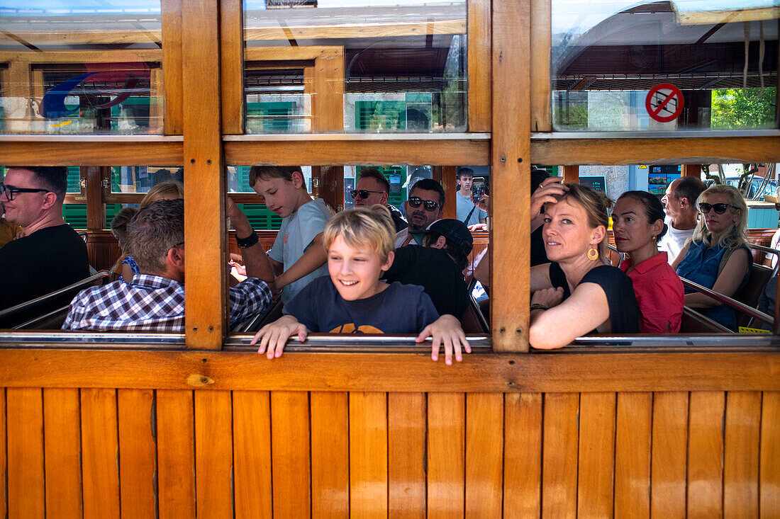 Passengers of the tren de Soller train vintage historic train that connects Palma de Mallorca to Soller, Majorca, Balearic Islands, Spain, Mediterranean, Europe.