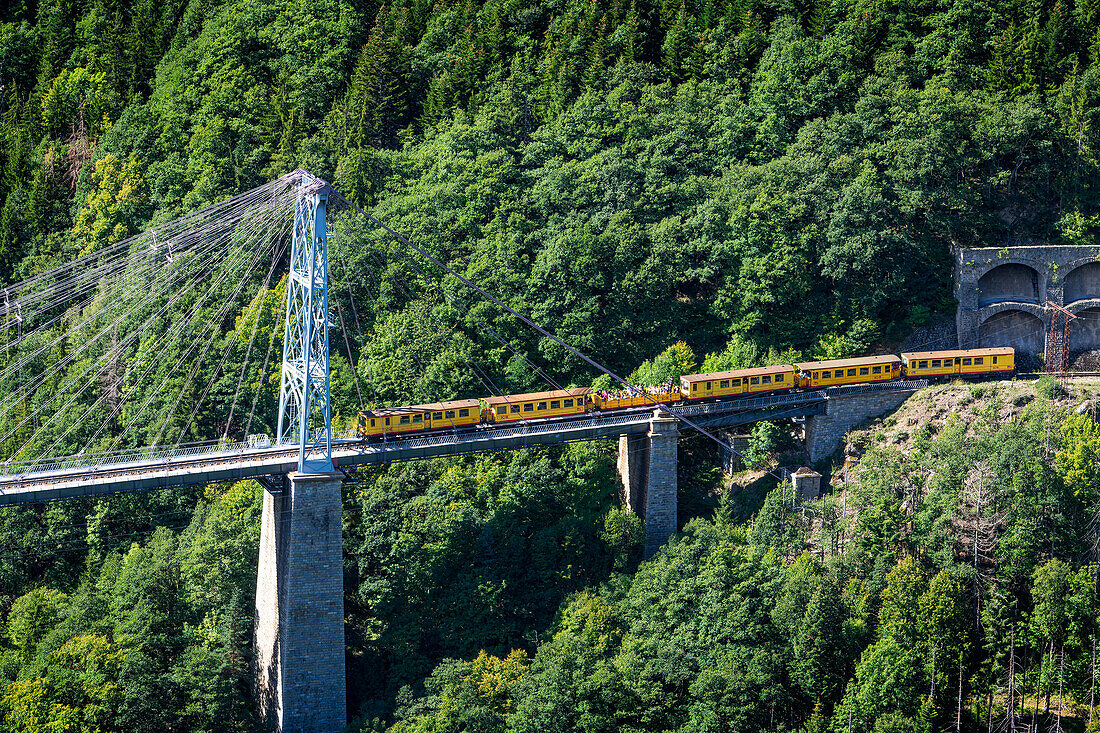 Petit train jaune train in the suspension bridge at Pont Gisclard bridge between Sauto and Planès, France.