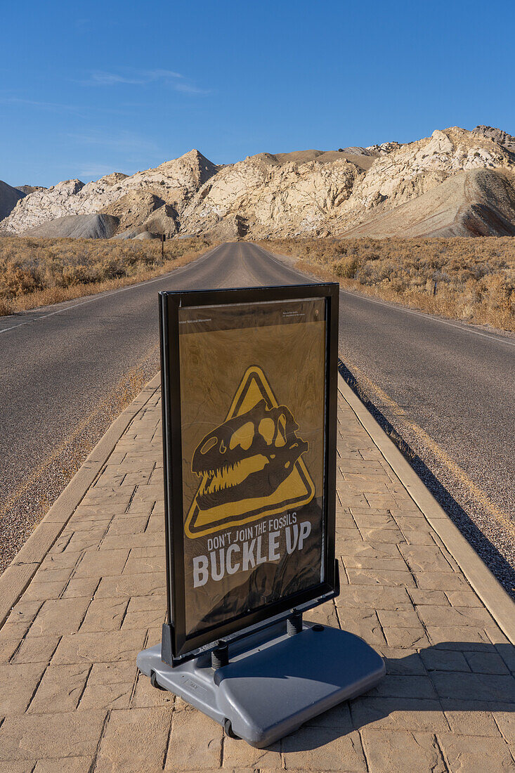 A traffic sign at the entrance to Dinosaur National Monument saying, "Don't Join the Fossils. Buckle Up."