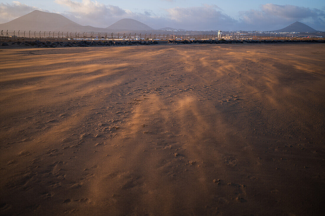 Wind blows sand on a beach in Lanzarote, Canary Islands, Spain