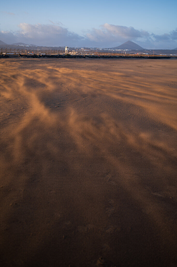 Wind blows sand on a beach in Lanzarote, Canary Islands, Spain