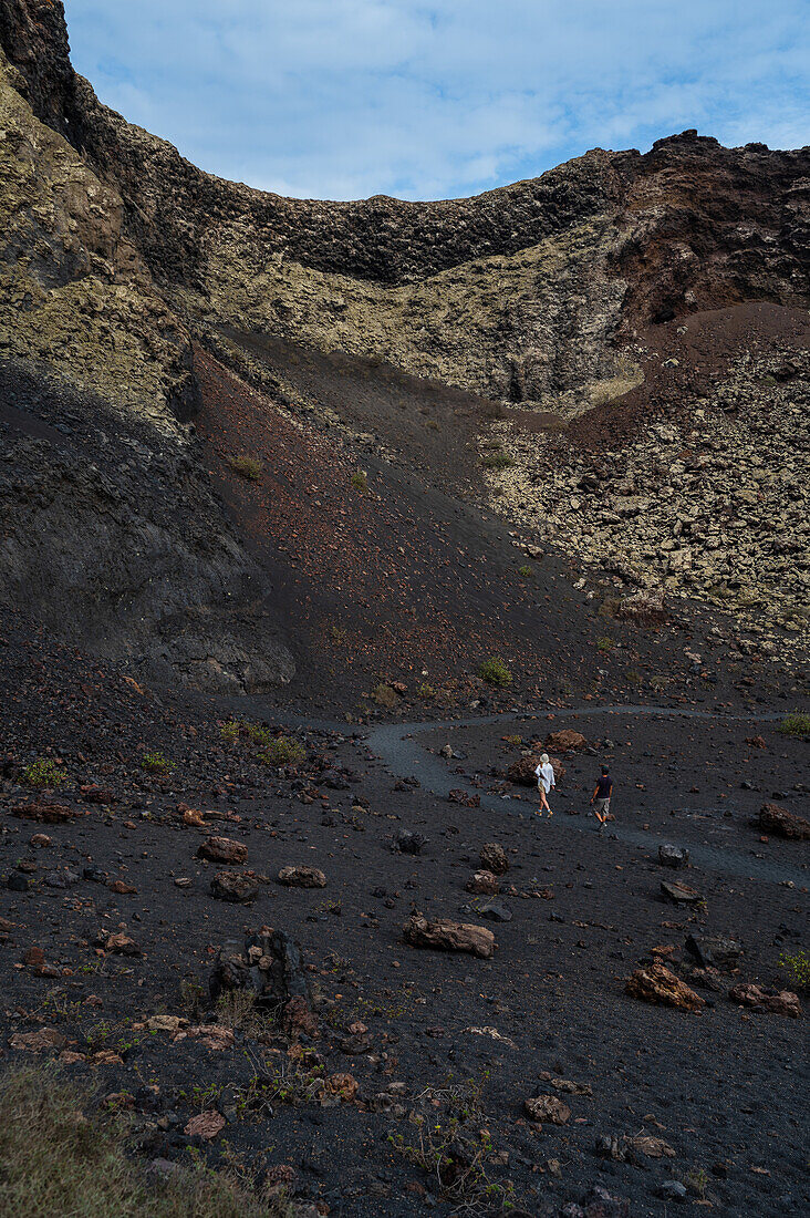 Volcan del Cuervo (Crow volcano) a crater explored by a loop trail in a barren, rock-strewn landscape