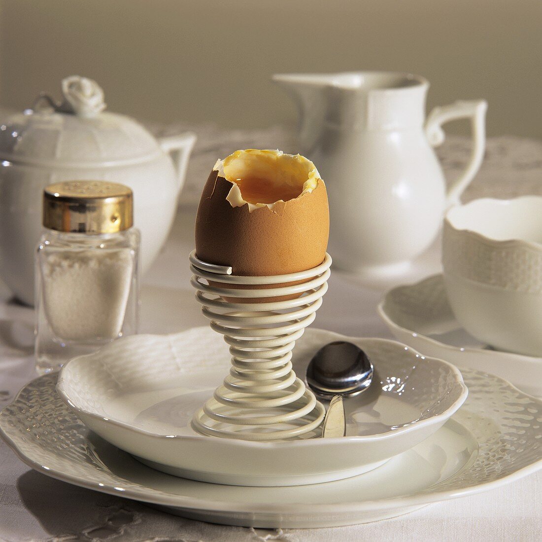 White breakfast setting with breakfast egg & salt on table
