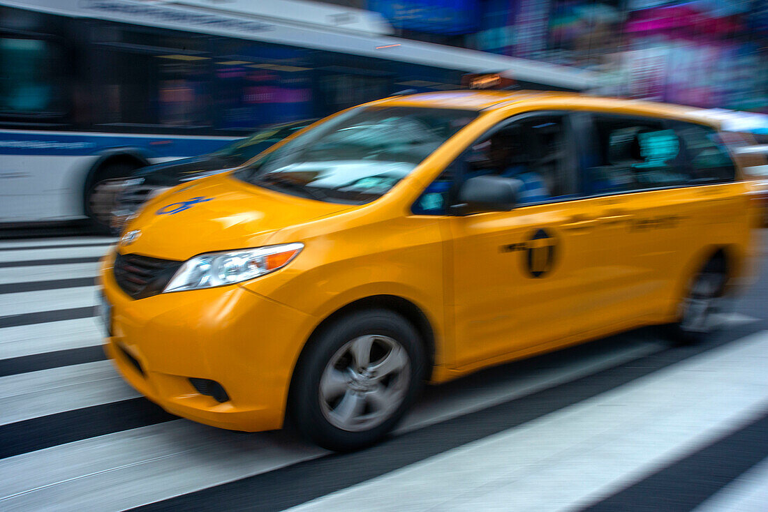 Yellow Taxicabs on Times Square, New York City, USA. Yellow Taxi Cabs Lined Up Waiting At Stop Sign In Early Evening Light, Times Square, New York.