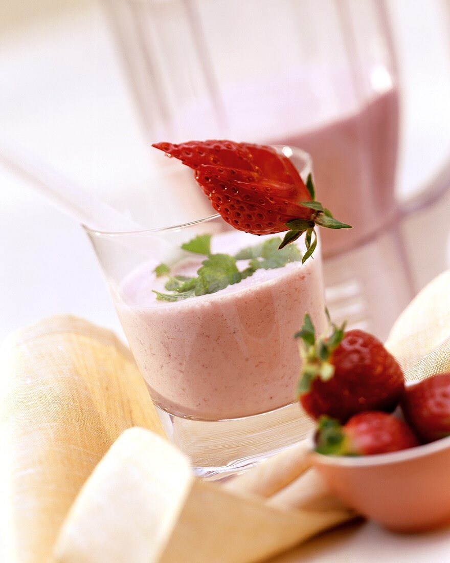 Strawberry yoghurt mix in glass & fresh strawberries