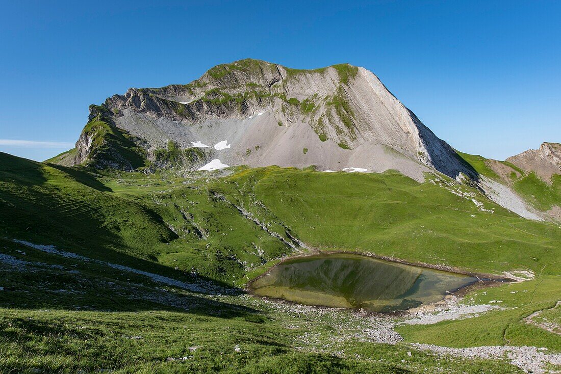 France, Haute Savoie, Aravis Massif, Manigod, hiking Lake Charvin, the lake and the north face of Mount Charvin