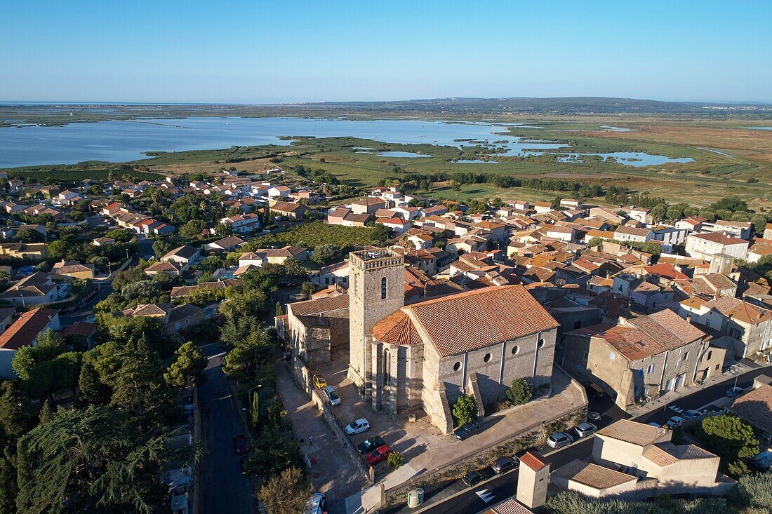 France, Herault, Vendres, and its ponds, in the foreground the Saint-Etienne church, dated 13th-17th century, aerial view