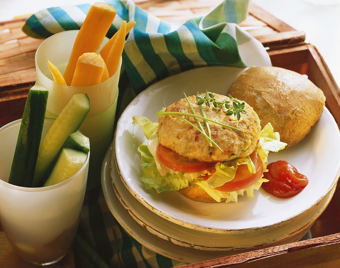 Geflügelburger mit Ketchup auf Teller & Rohkoststangen