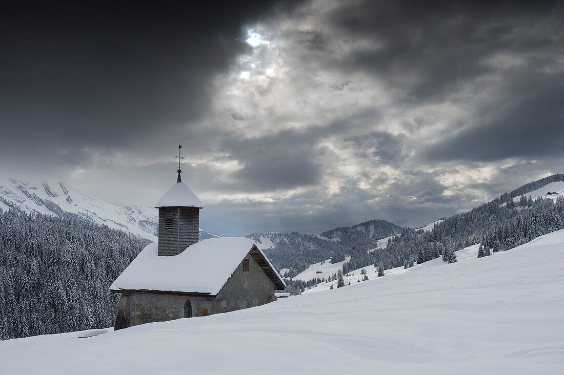 France, Haute Savoie, Le Grand Bornand, the chapel of the Duche under the snow at dusk