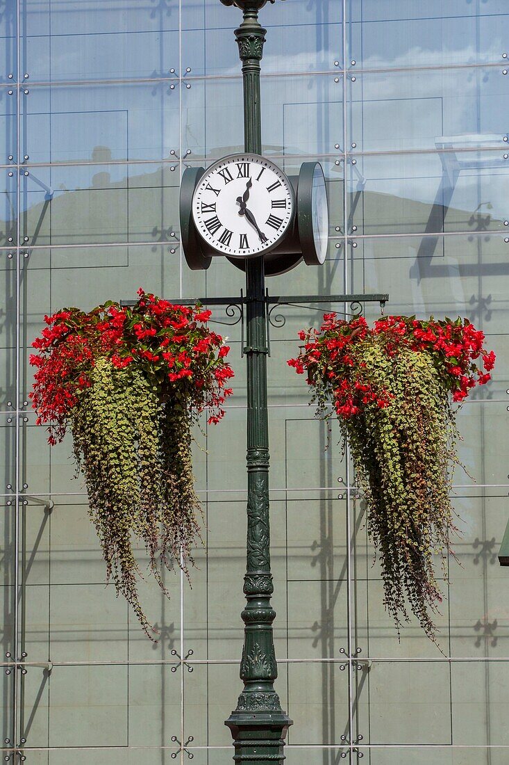 France, Hauts de Seine, Puteaux, Republique street, clocks and flower boxes