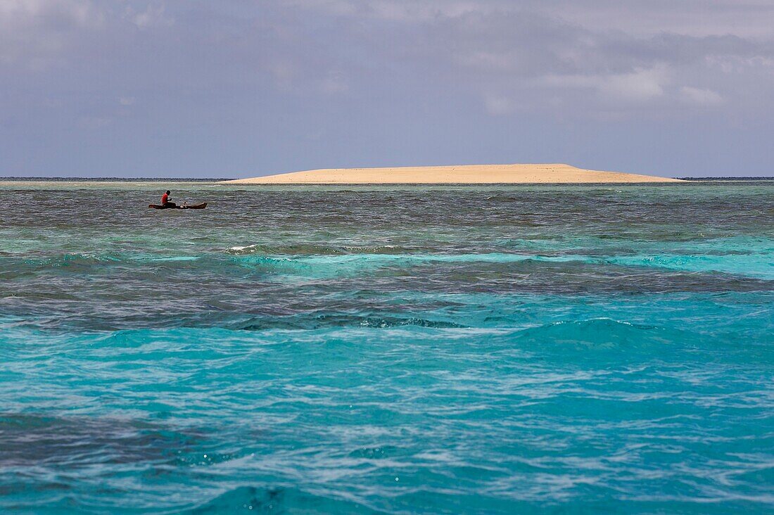 France, Mayotte island (French overseas department), Grande Terre, M'Tsamoudou, islet of white sand on the coral reef in the lagoon facing Saziley Point, fisherman in dugout