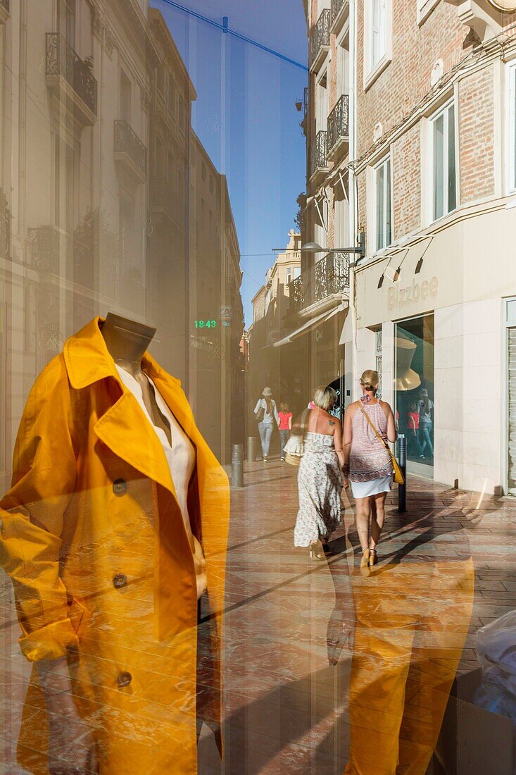 France, Pyrenees Orientales, Perpignan, city center, reflection of a street scene of the city center in the window of a shop