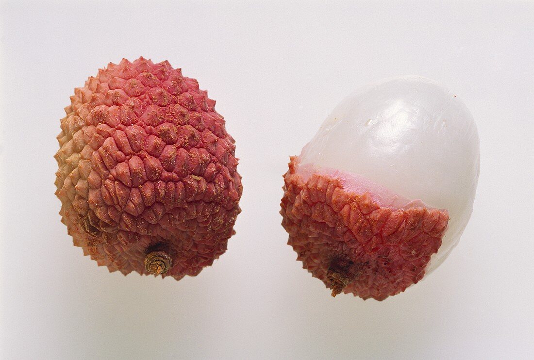 A whole lychee and half a peeled lychee