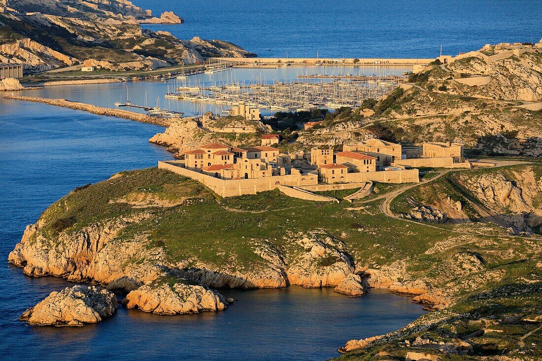 France, Bouches du Rhone, Calanques National Park, Marseille, 7th arrondissement, Frioul Islands Archipelago, Ratonneau Island, Caroline Hospital, port and Pomègues island in background (aerial view)