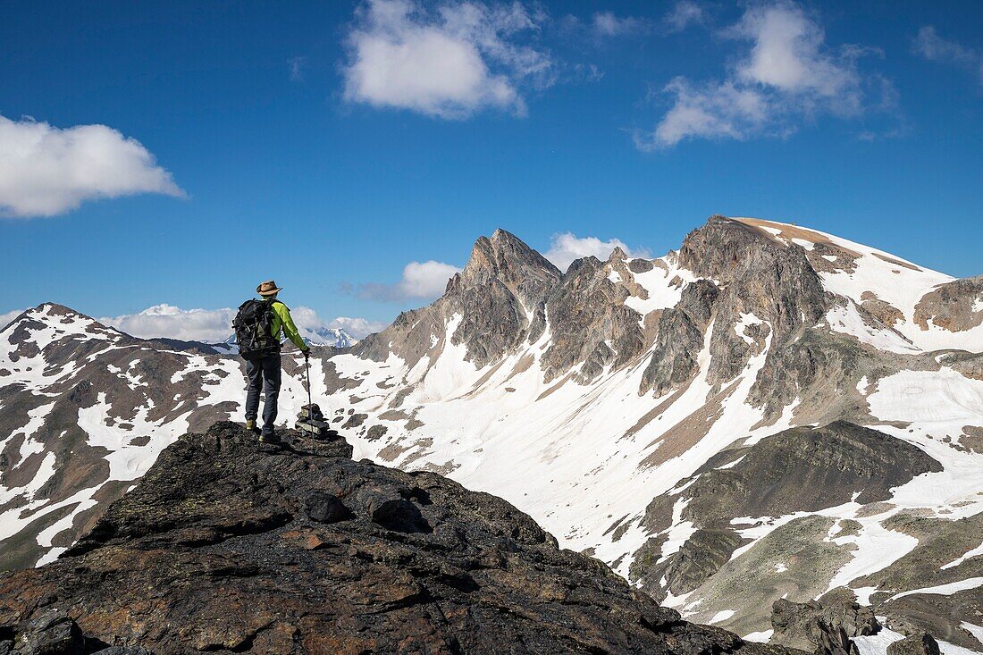 France, Hautes Alpes, Nevache, La Clarée valley, hiker facing the Roc de Valmeinier (3025m)