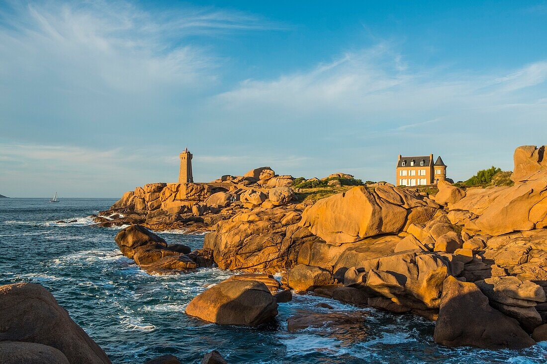France, Cotes d'Armor, Ploumanach, Perros-Guirec, Pink granite coast, the lighthouse of Ploumanac'h or lighthouse of Mean Ruz at sunset on the footpath of Customs or GR Grande 34 hiking trail