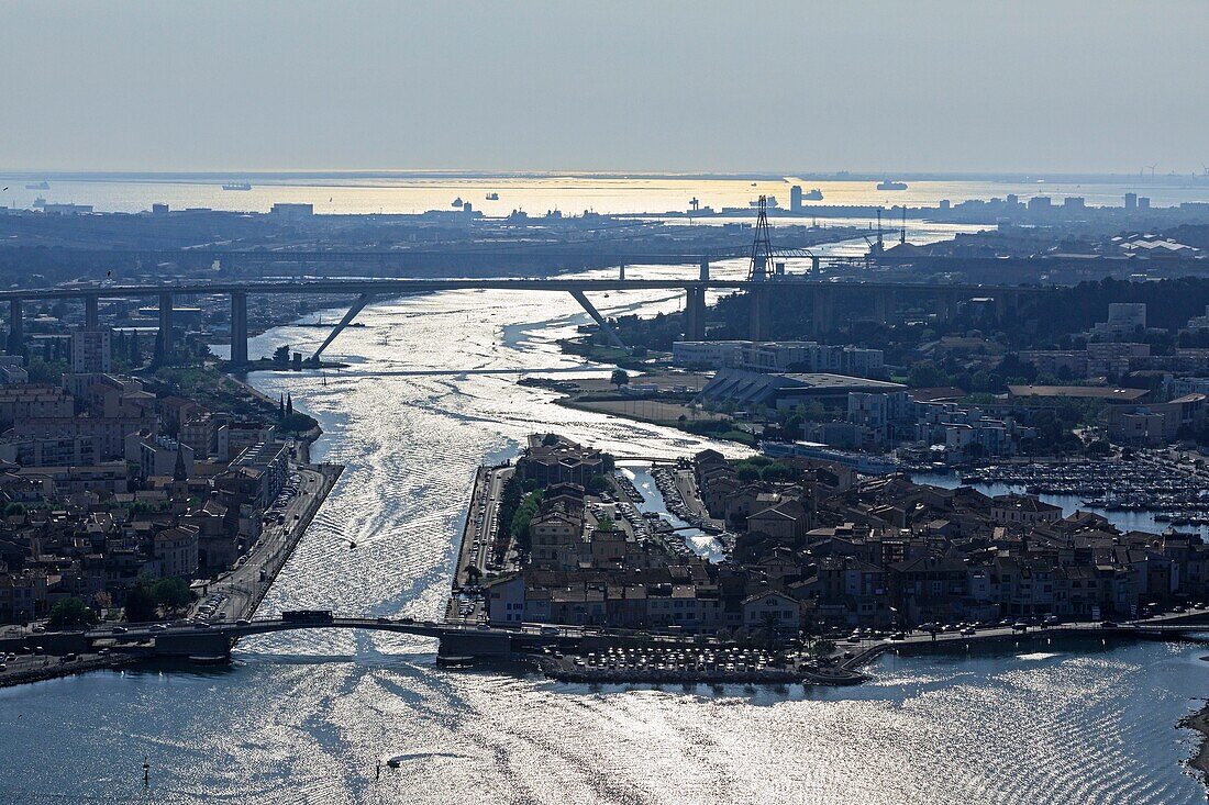 France, Bouches du Rhone, Martigues, Berre pond, Lift bridge on the Gallifet canal, Caronte channel and A55 motorway bridge (aerial view)