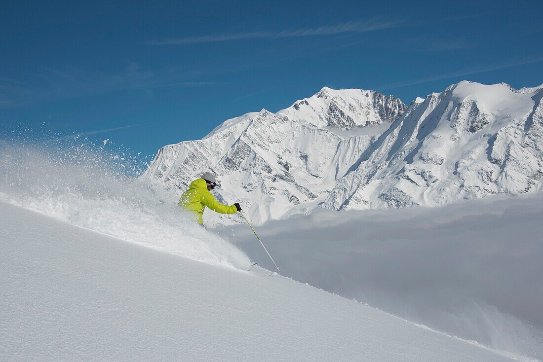 France, Haute Savoie, Massif of the Mont Blanc, the Contamines Montjoie, the skier in powdery outside the ski area and the summits of the massif of the Mont Blanc