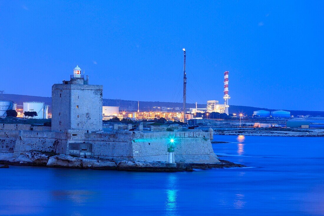 France, Bouches du Rhone, Martigues, Fort de Bouc lighthouse (12th to 17th centuries), Vauban fort and Lavéra petrochemical platform in the background