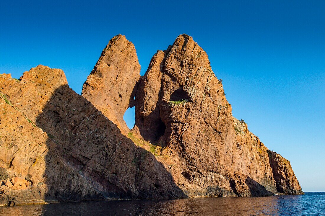 France, Corse du Sud, Porto, Gulf of Porto listed as World Heritage by UNESCO, natural arch in the tormented cliffs with ocher shades of the nature reserve of Scandola