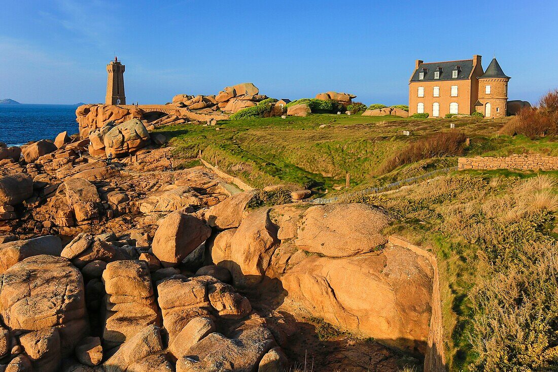 France, Cotes d'Armor, Pink Granite Coast, Perros Guirec, on the Customs trail or GR 34 Grande Randonnee path, the Ploumanac'h lighthouse or Mean Ruz lighthouse at sunset