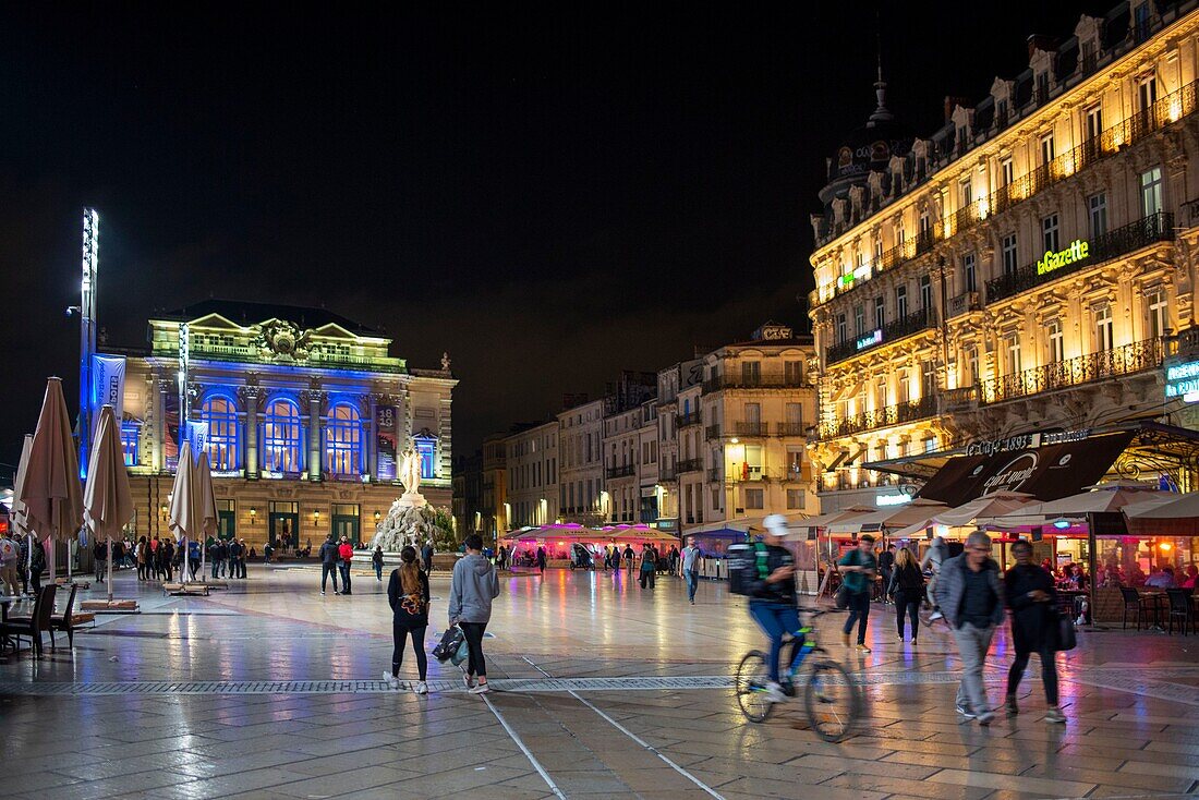 Frankreich, Herault, Montpellier, Comedie Place, geht und kommt von Fußgängern und Fahrradfahrern bei Nacht