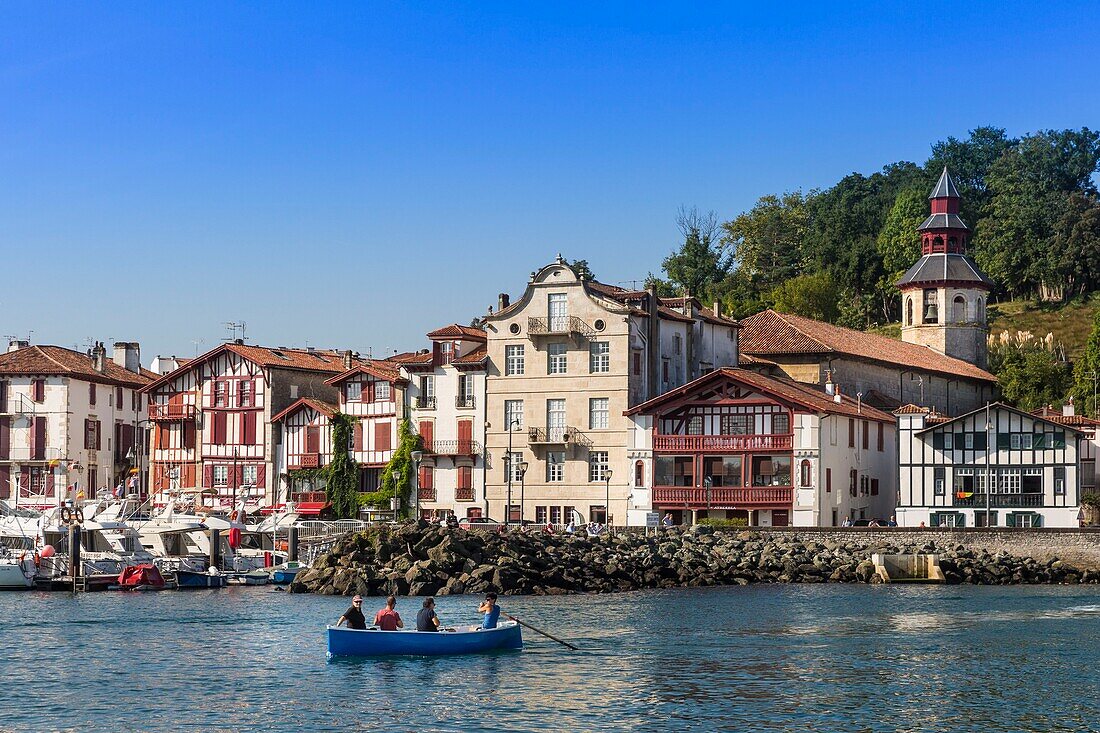 France, Pyrenees Atlantiques, Bask Counrty, Ciboure, small boat coming out of the port of Saint Jean de Luz with in bottom the city of Ciboure