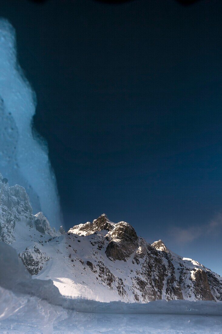 France, Isère (38), Belledonne, Chamrousse, Robert lakes bordered and dominated on the east by Petit Van (2,439 meters), Grand Van (2,448 meters) and Grand Sorbier (2,526 meters), reflecting the mountain peaks through a hole dug in the ice to allow diving